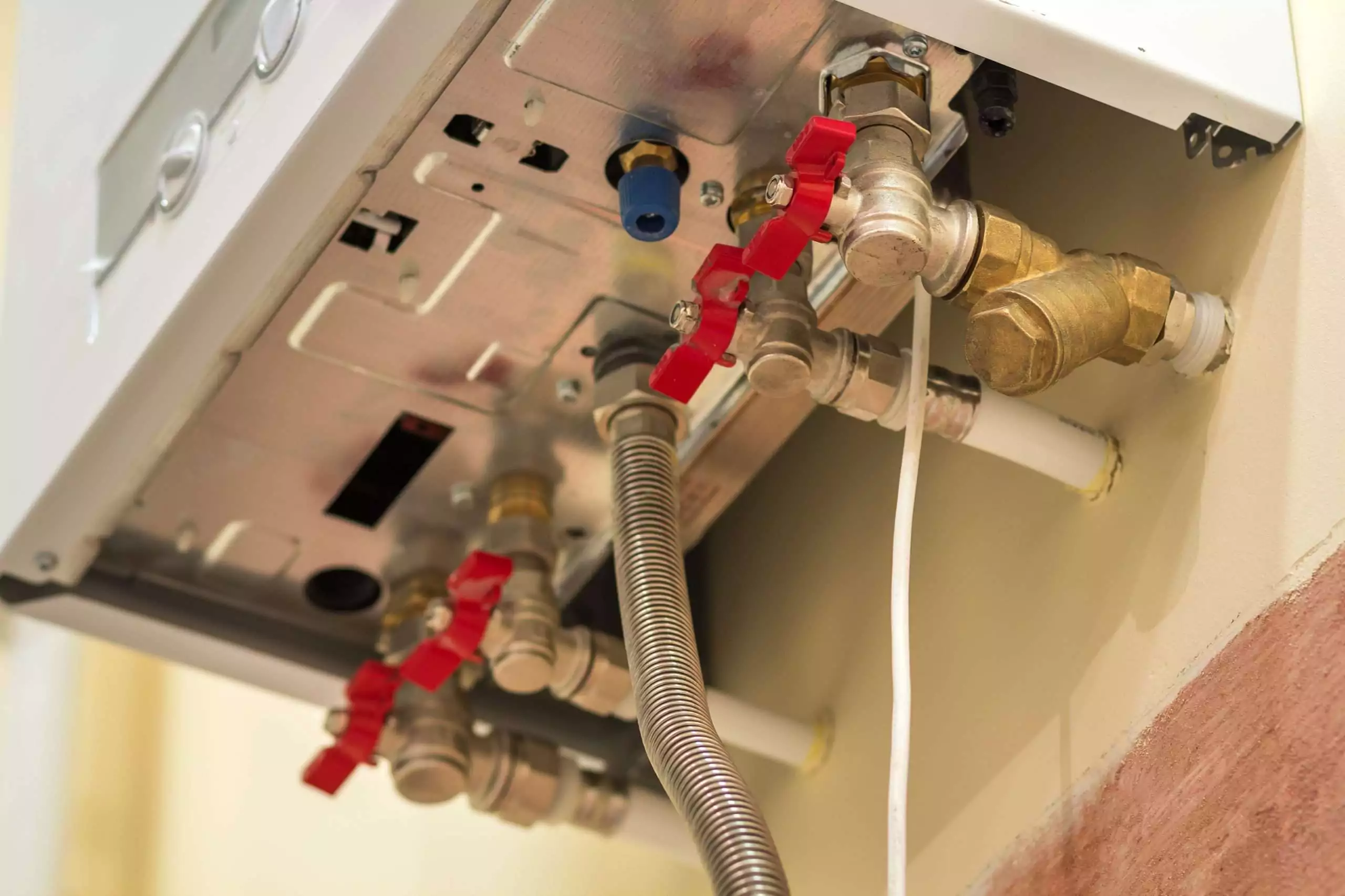 Gas water heater service life assessment by Master Plumber - James Armstrong Plumbing inspecting aging residential gas tank water heater for sediment damage anode condition and burner efficiency to estimate remaining lifespan in DFW home