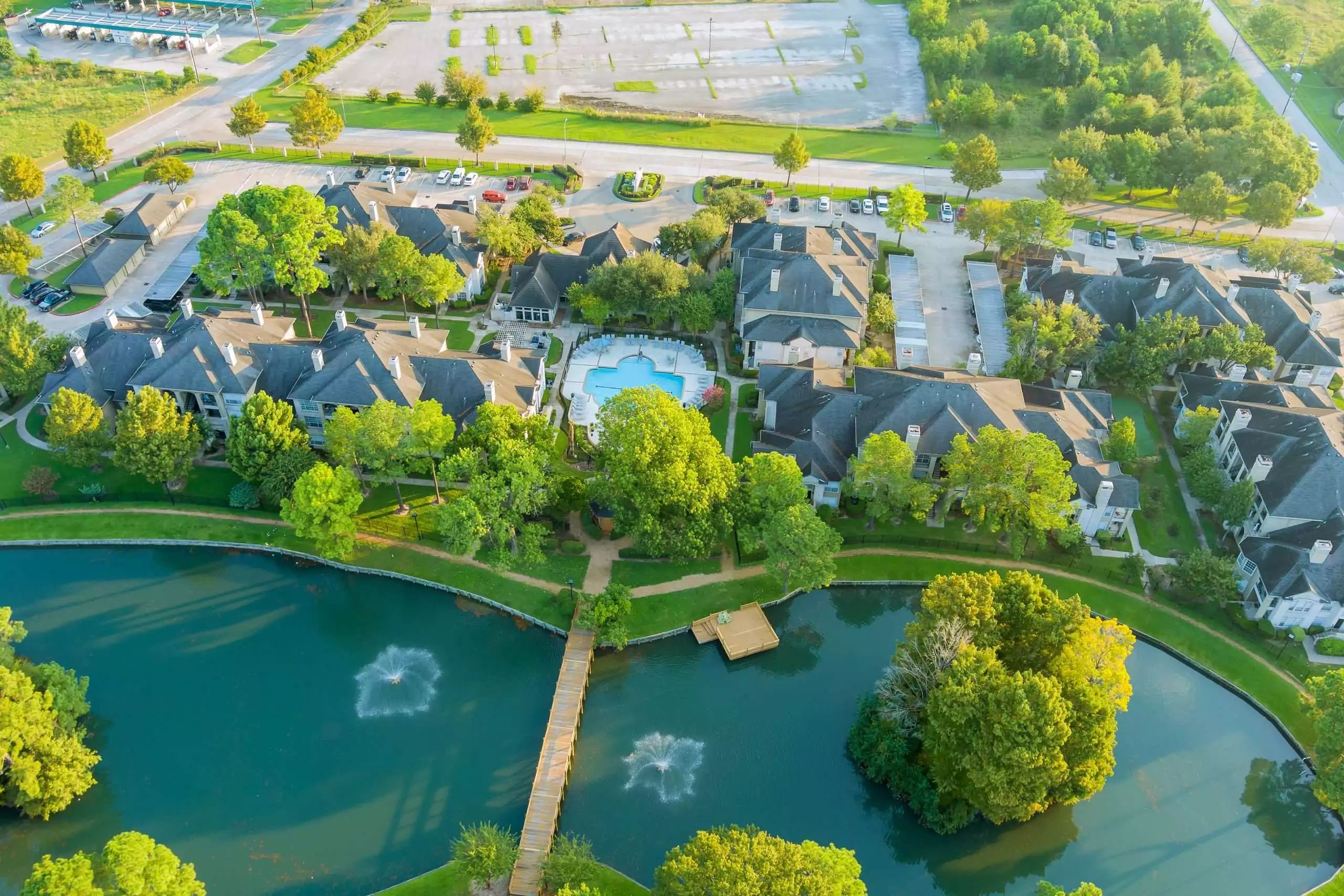 Aerial view of residential houses and driveways neighborhood during a fall sunset in Texas