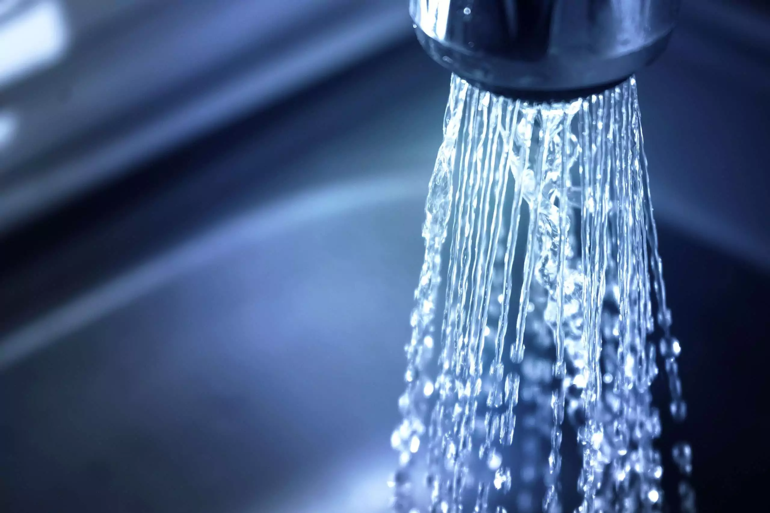 Clear Water Flowing From a Chrome Faucet