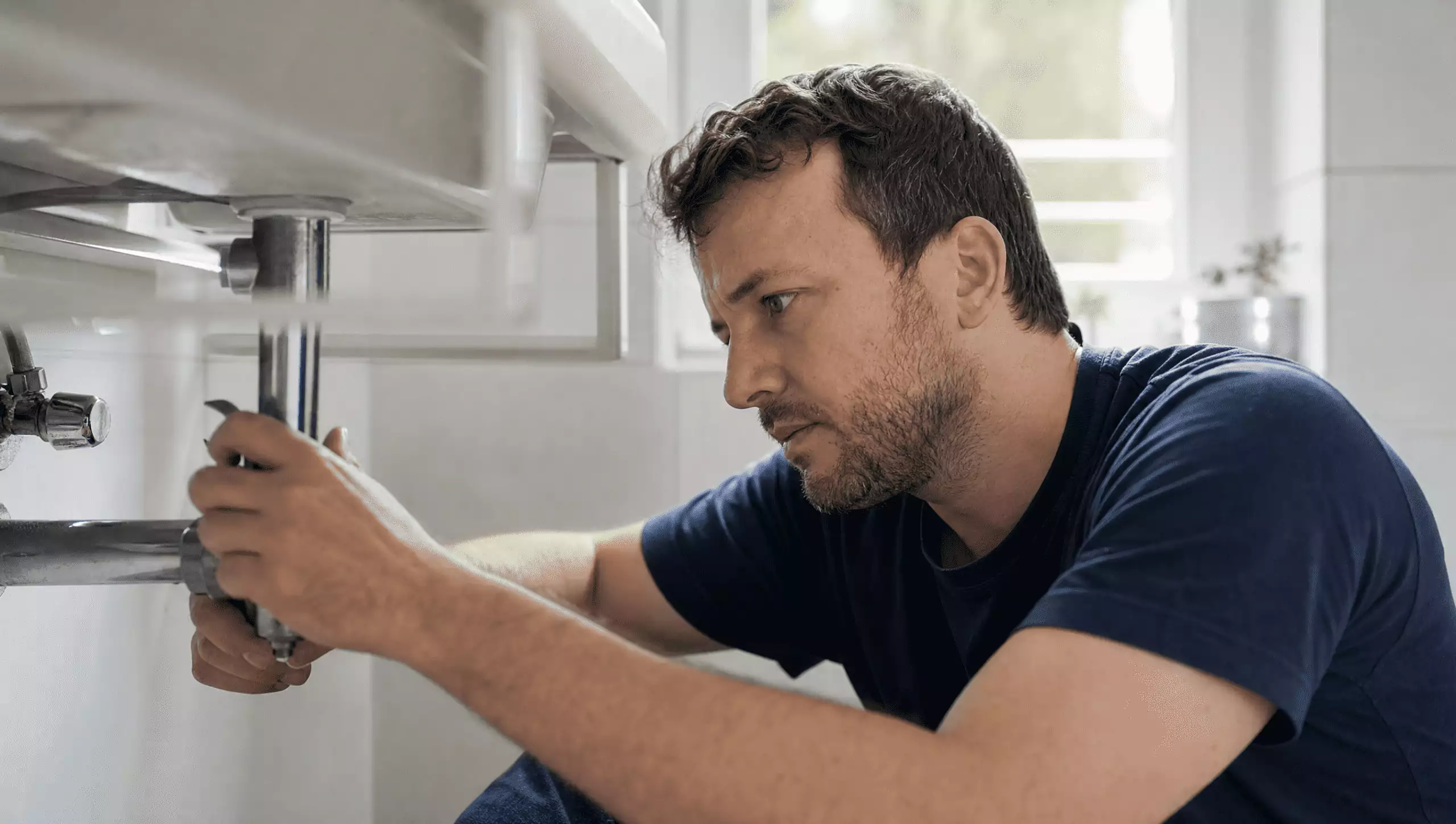 Man doing his own plumbing maintenance at his home