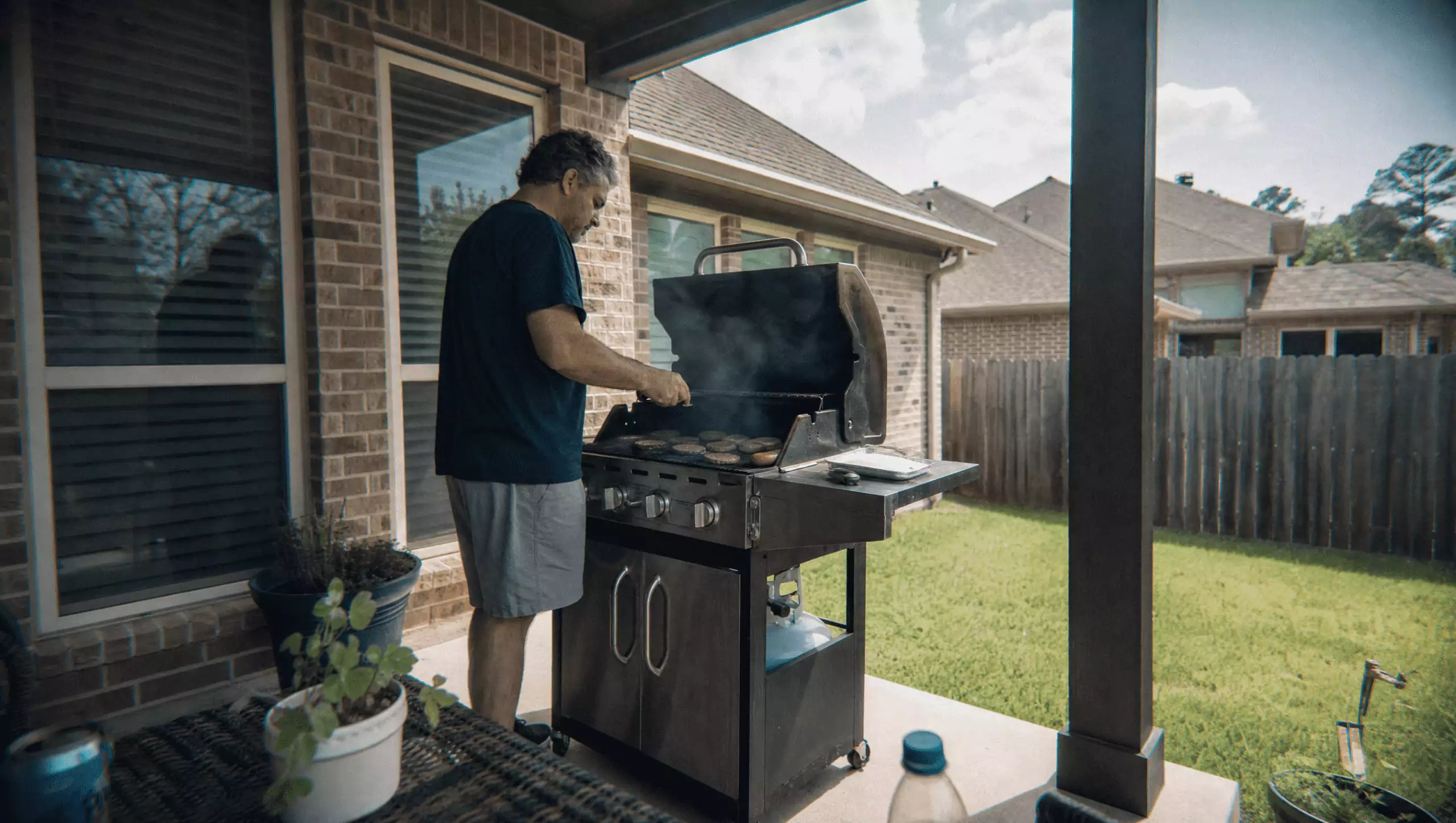 man outside on the grill
